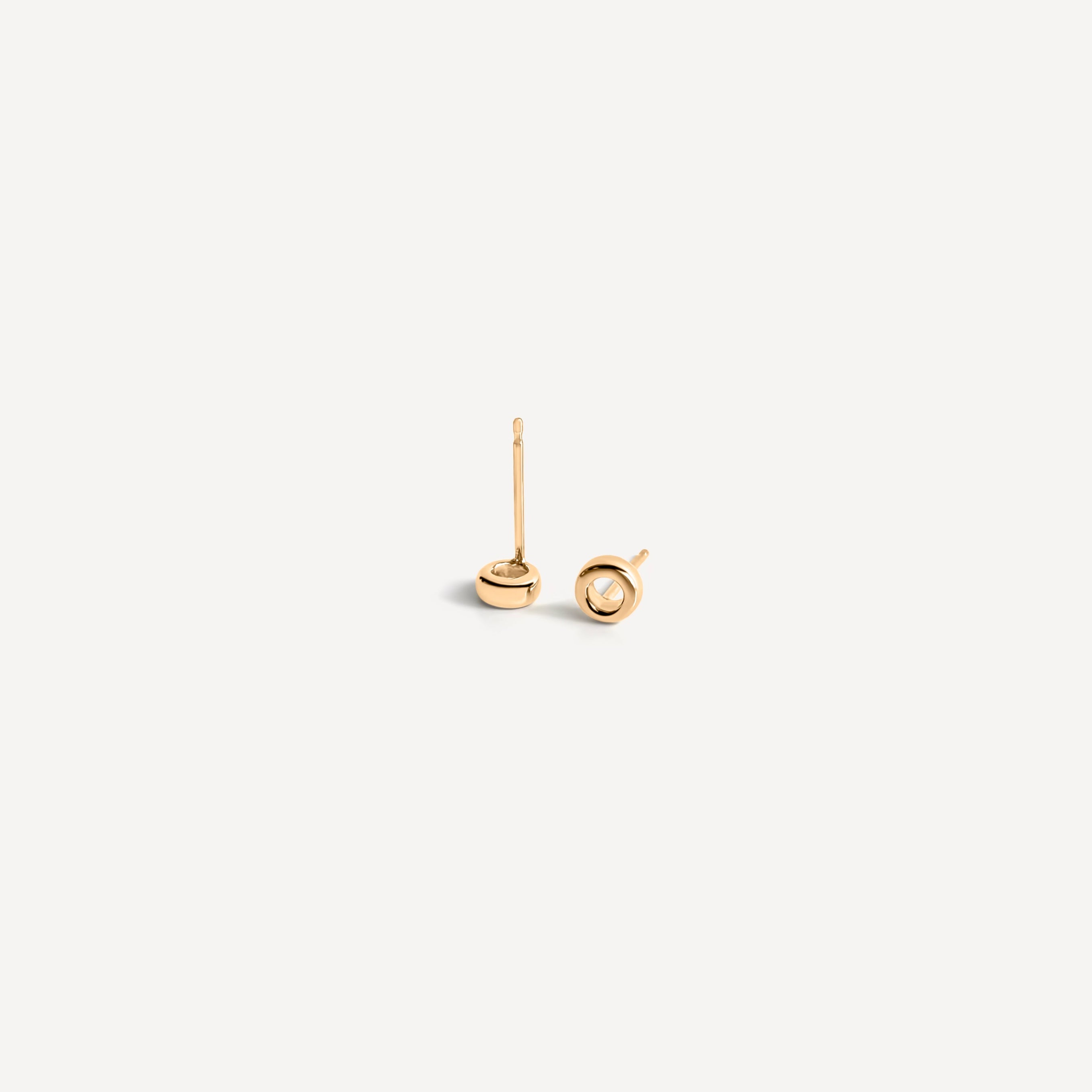 Minimal open circle gold stud earrings featuring hollow center design, perfect for everyday minimalist jewelry style.