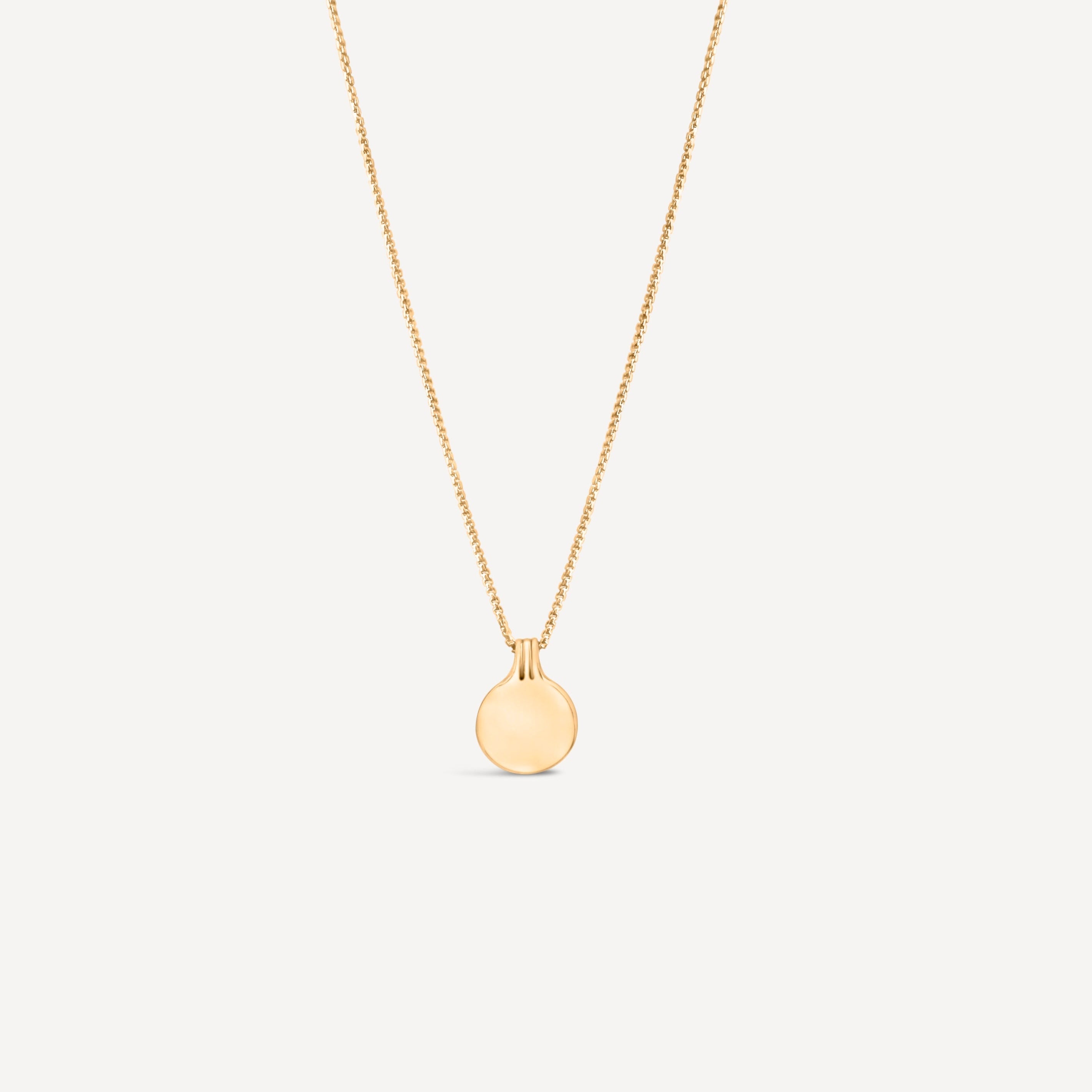 circle 14k solid gold pendant on white background with unique bail handmade
