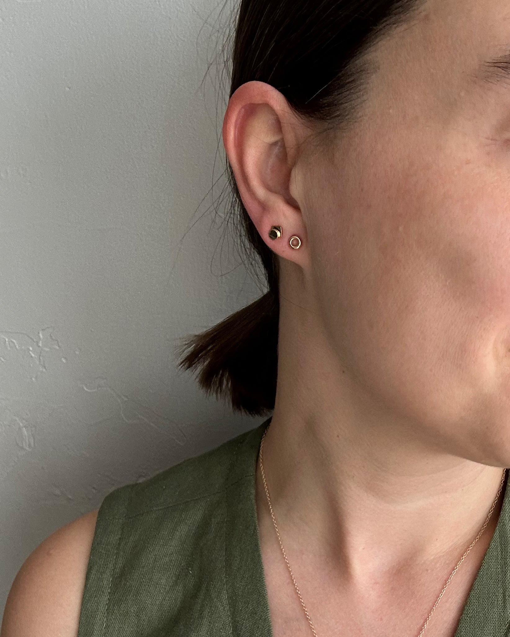 perfectly imperfect jewelry, non traditional fine jewelry recycled handmade circle studs on model