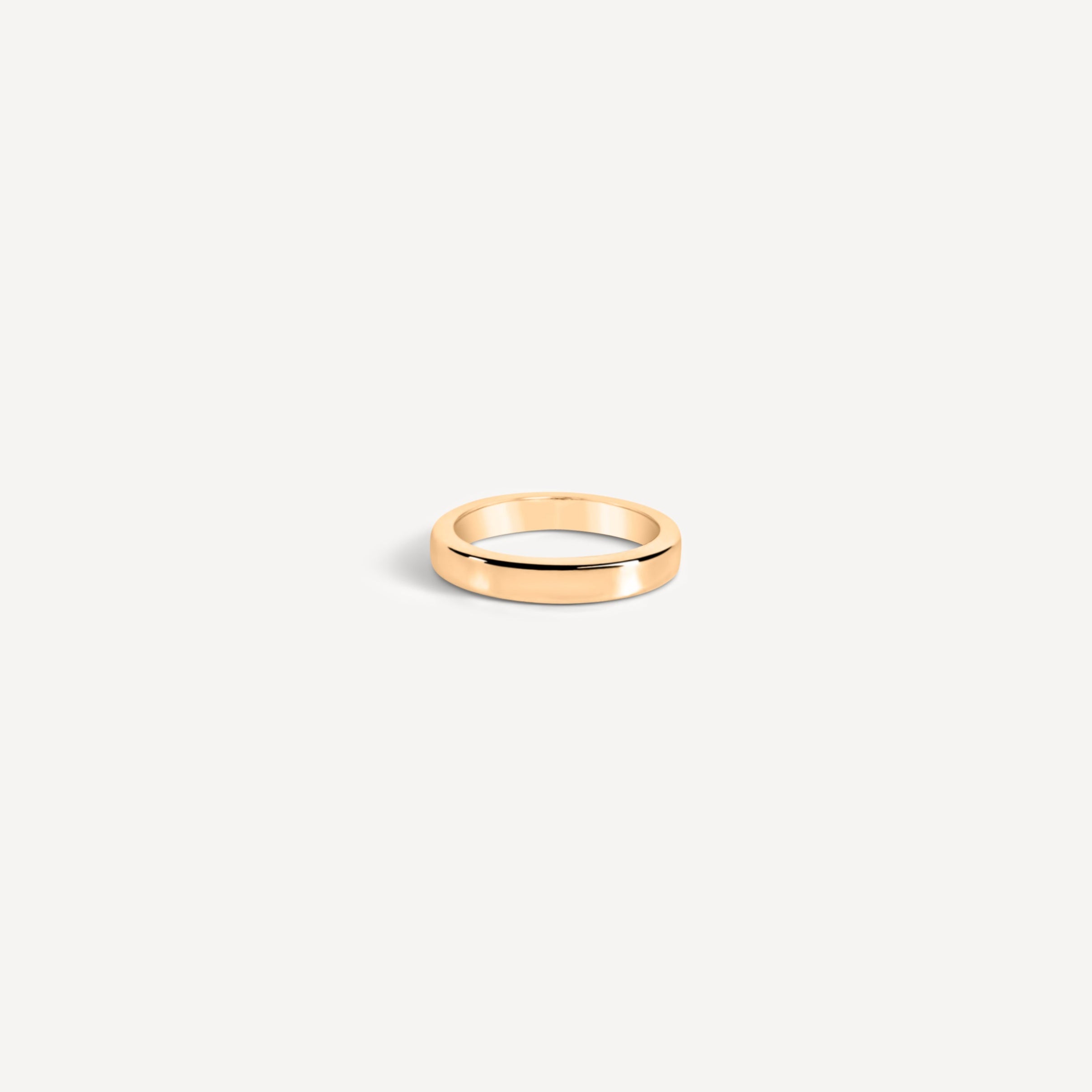perfectly imperfect jewelry, non traditional fine jewelry everyday thick wedding band in solid recycled 14k gold on a white flatlay background.