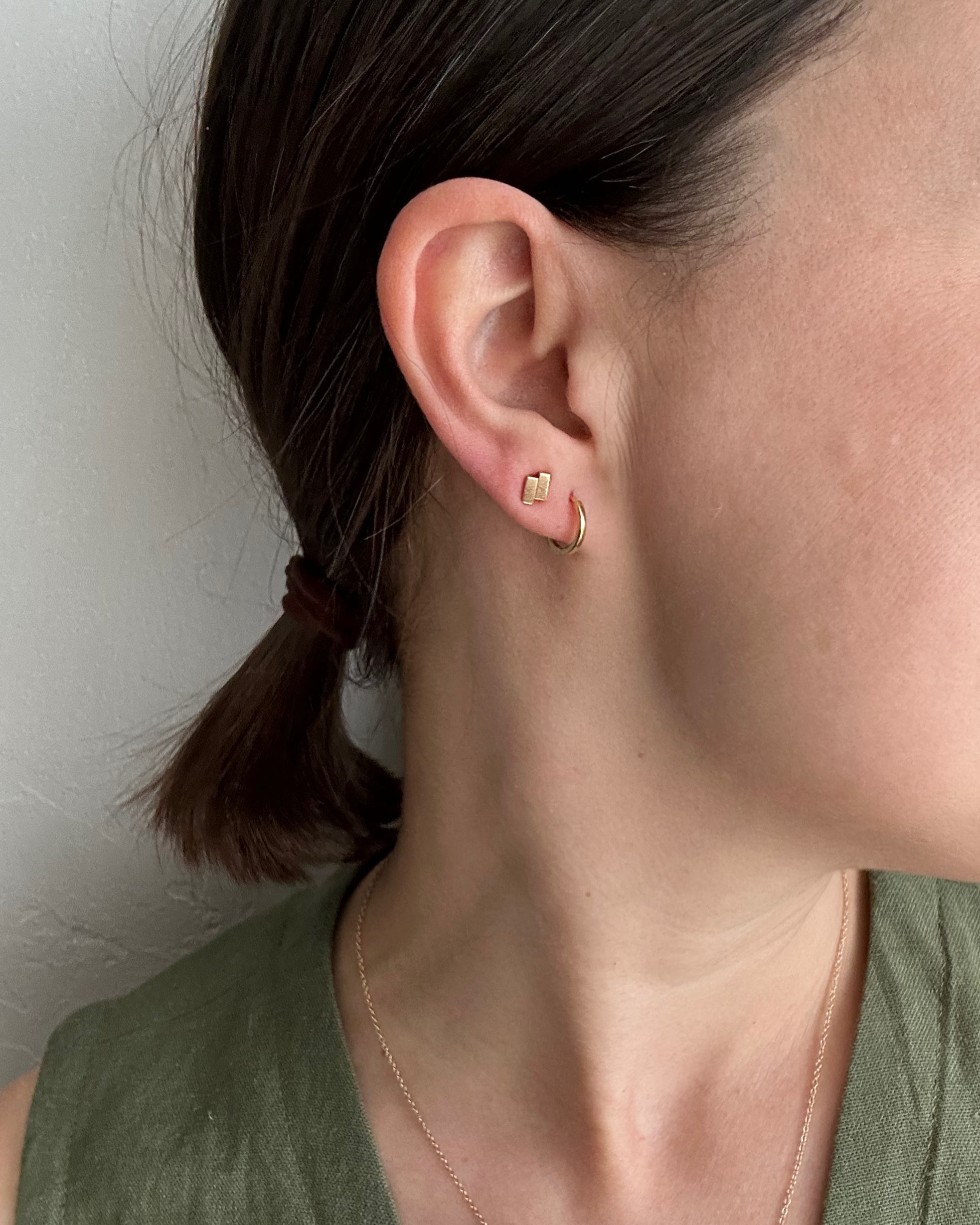 perfectly imperfect jewelry, non traditional fine jewelry geometric studs in solid recycled 14k gold on model