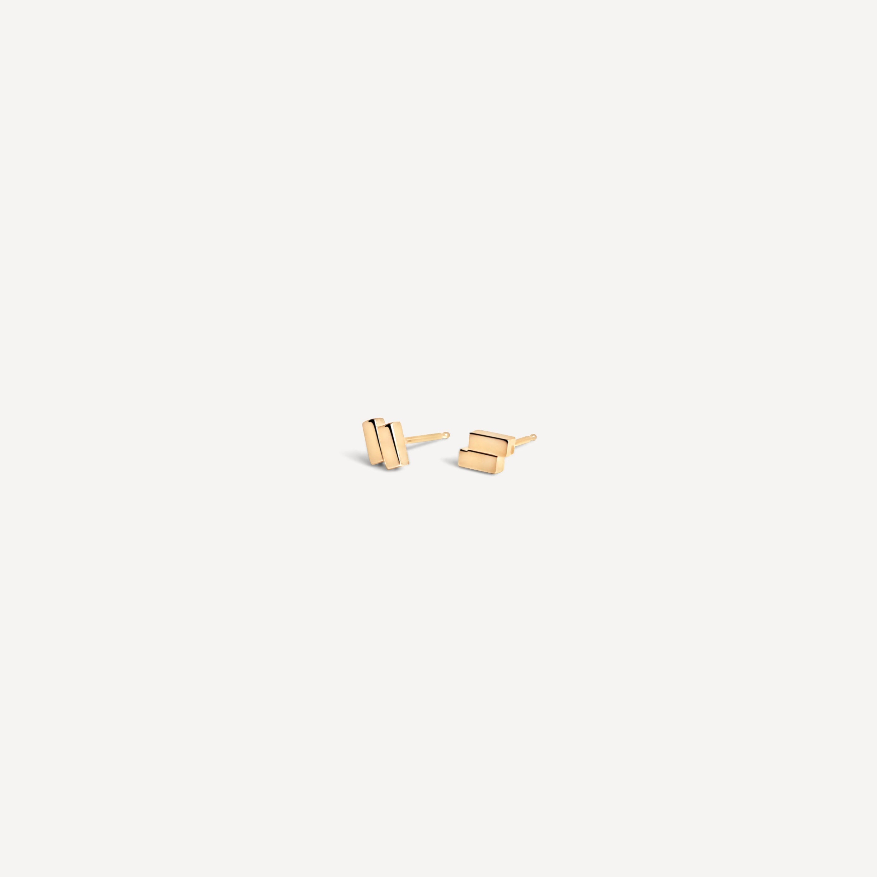 Contemporary gold bar studs displayed at angle, showcasing their minimal geometric silhouette for versatile styling.