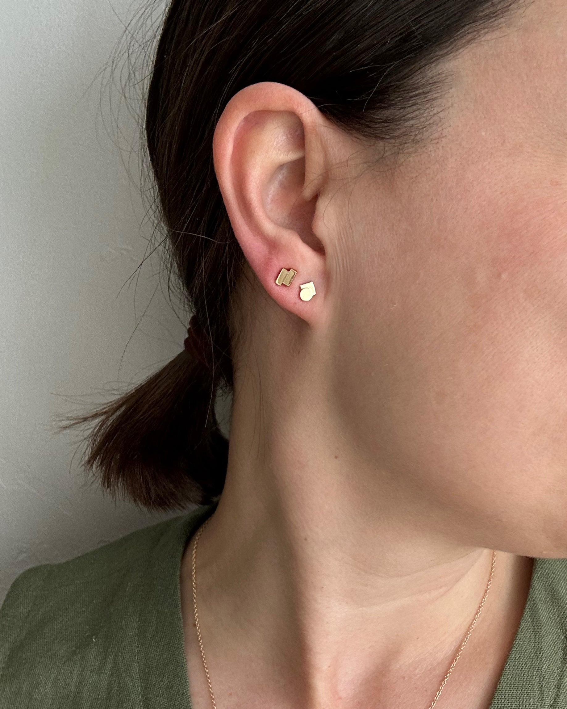 perfectly imperfect jewelry, non traditional fine jewelry geometric studs in solid recycled 14k gold on model