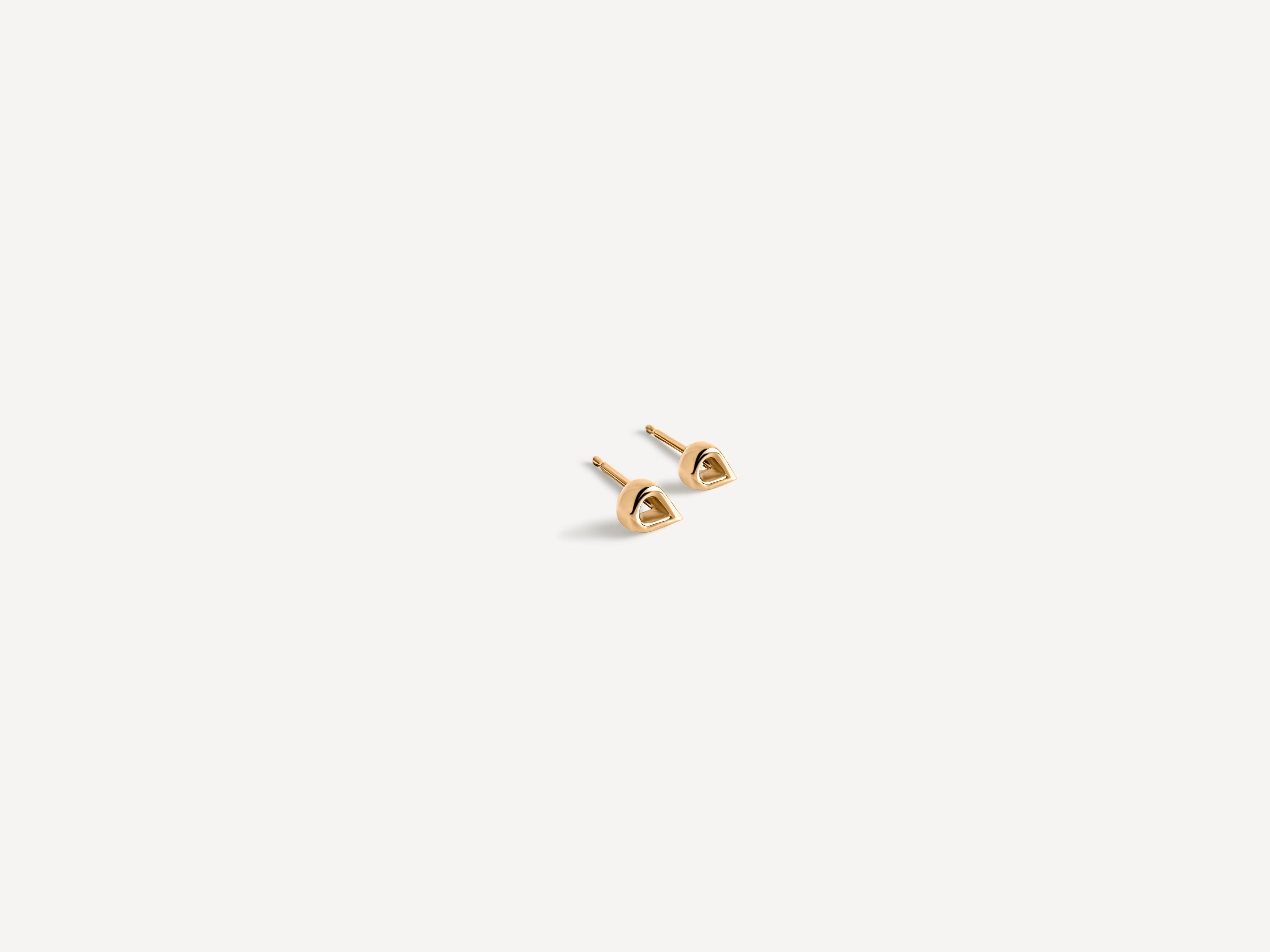 Modern teardrop gold studs styled with minimal jewelry for everyday elegant look, showcasing versatile design