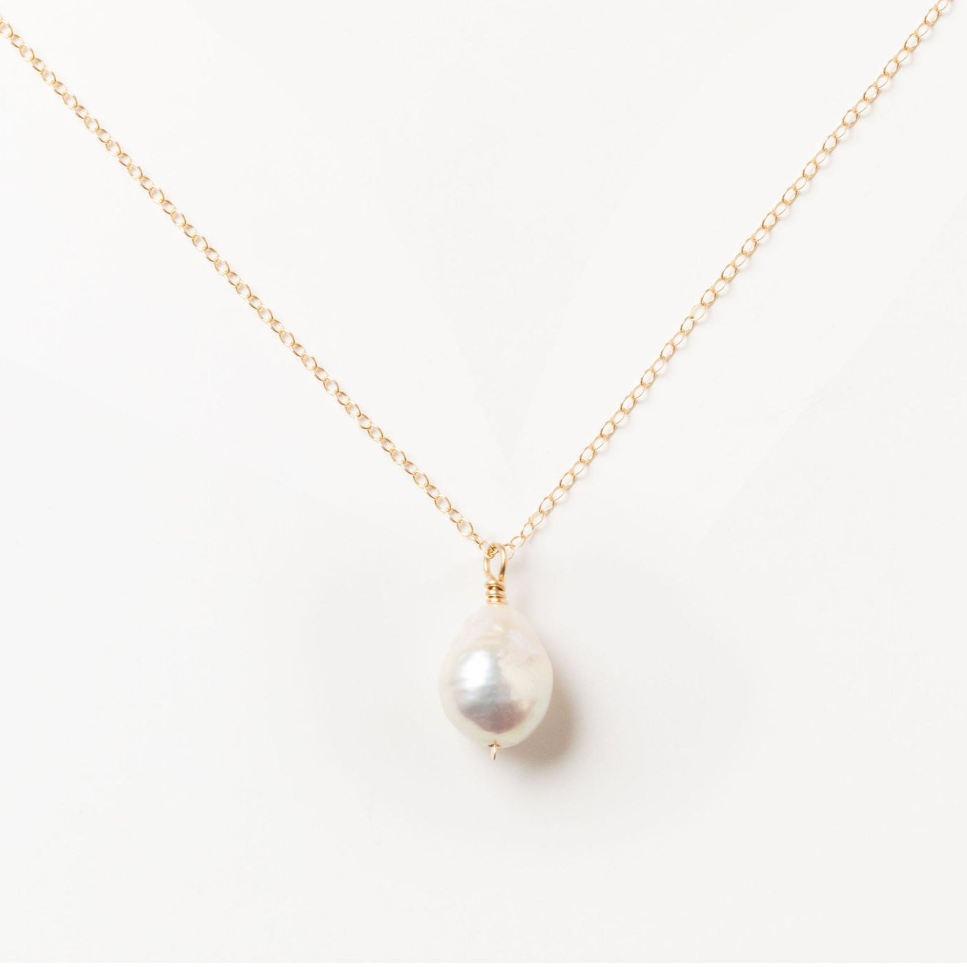 Handcrafted Baroque Pearl Necklace by Sheena Marshall Jewelry, featuring a unique Baroque pearl approximately 9-13mm, set on a 14k gold-filled chain with a hand-hammered, twisted bail, showcasing its organic beauty and artisanal craftsmanship