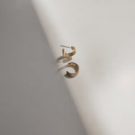 Closeup of Triple Hoop Earrings, highlighting their interwoven design and golden sheen.