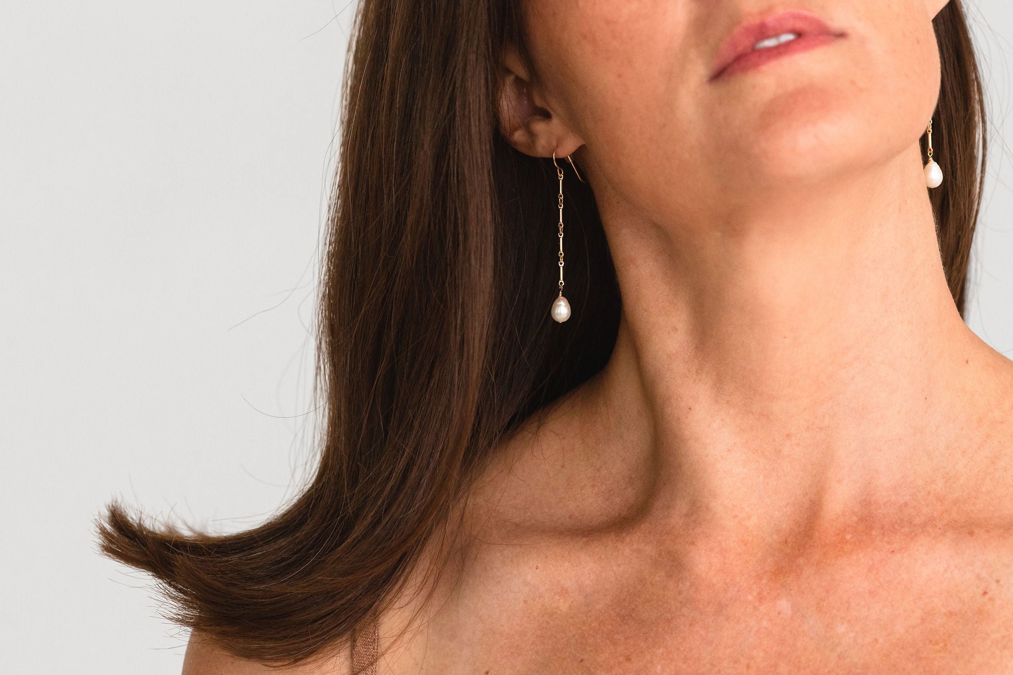 Detailed view of the gold-filled links and suspended freshwater pearls.