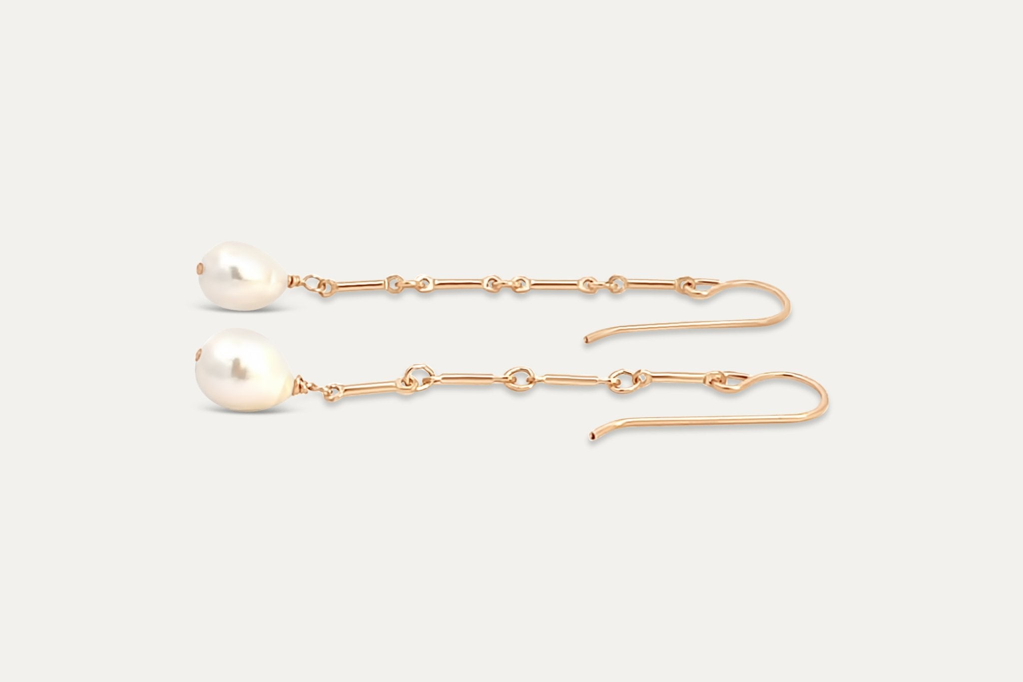 A flat lay image of the Florentine Earrings with gold-filled links and pearls.