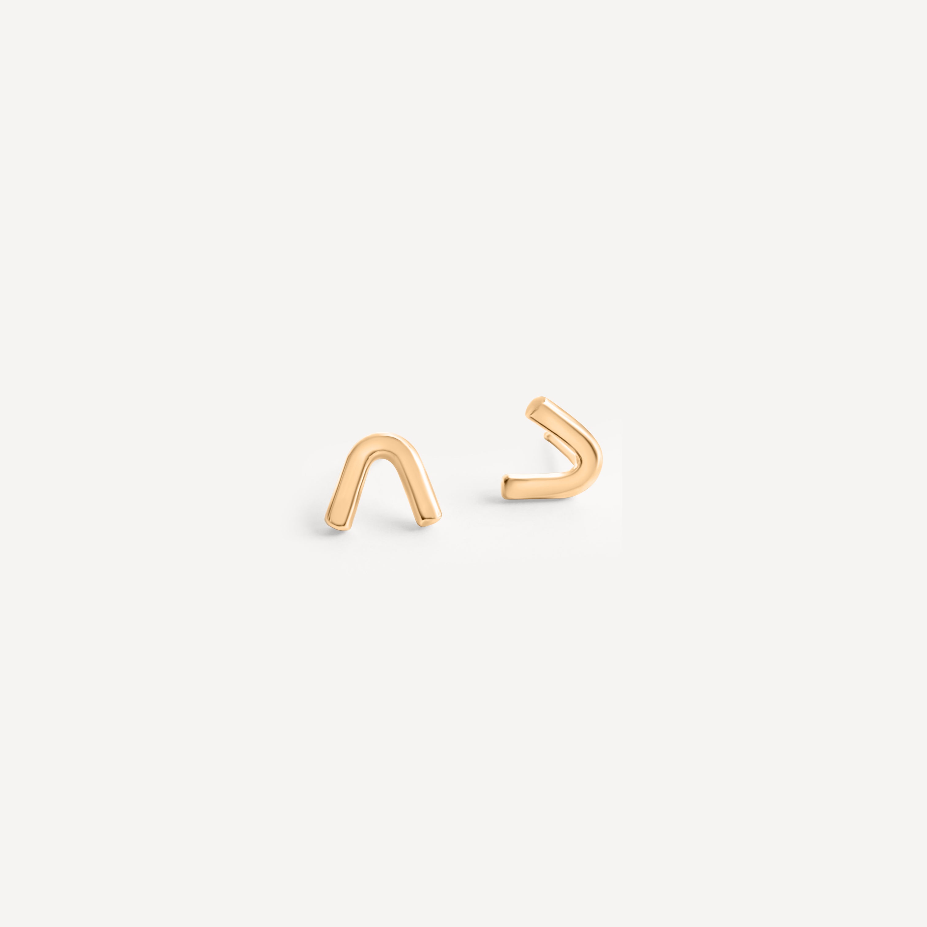 Handcrafted 14k gold arch stud earrings by Sheena Marshall Jewelry, measuring 7mm in height and 8.5mm in width, featuring an architectural design for refined casual elegance and heirloom quality.