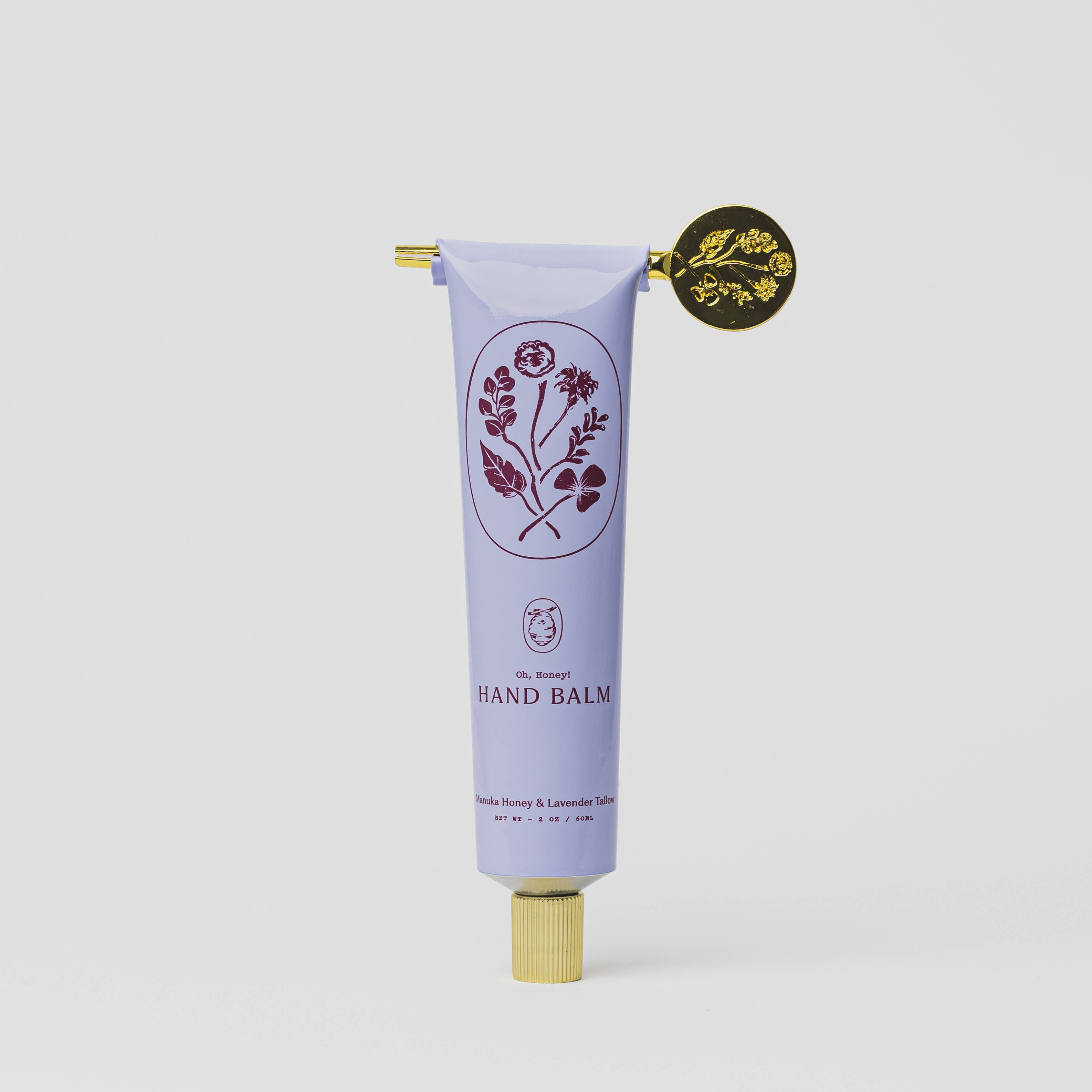 Tallow Hand balm tube with floral design and gold cap on a white background