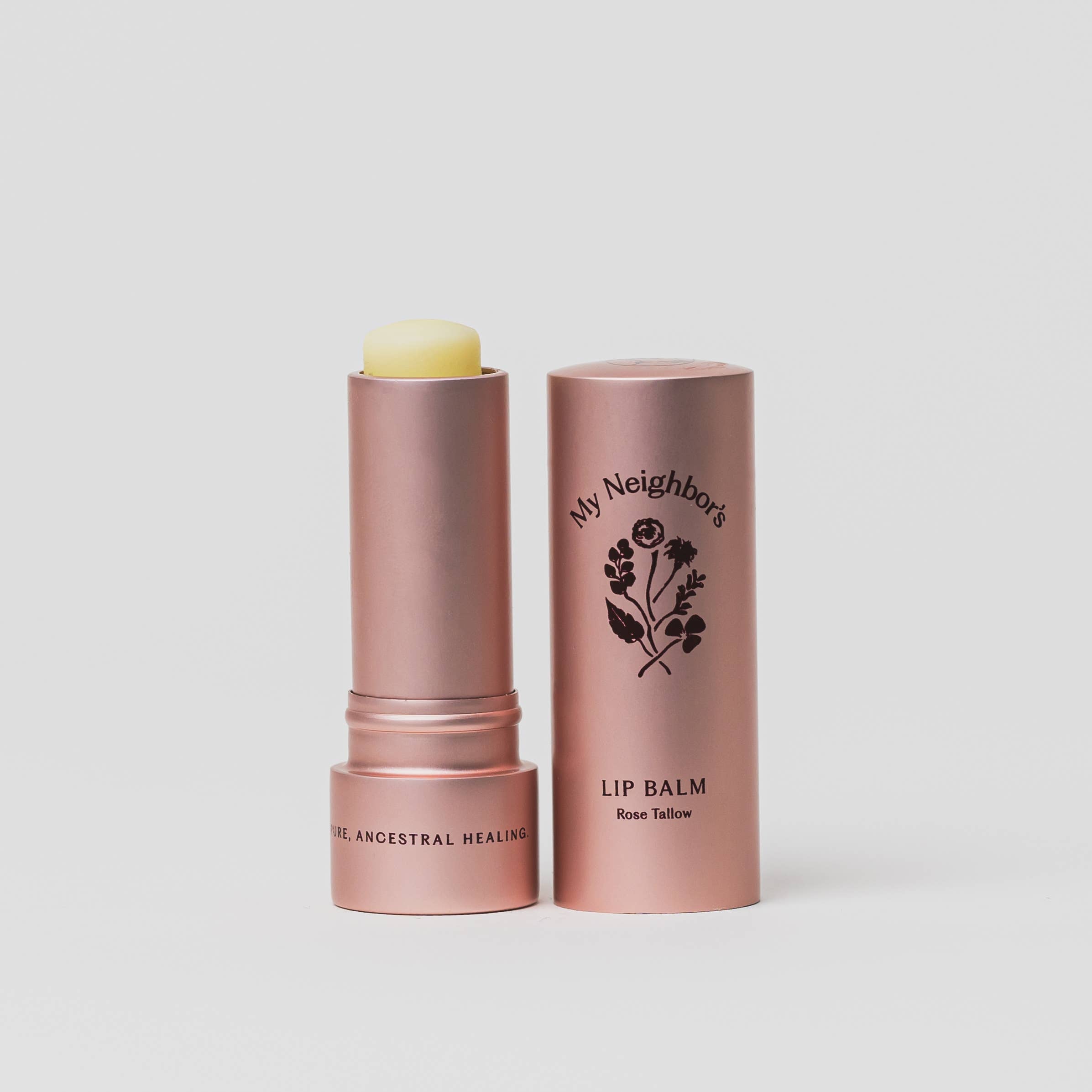Lip balm with rose gold container on a light gray background