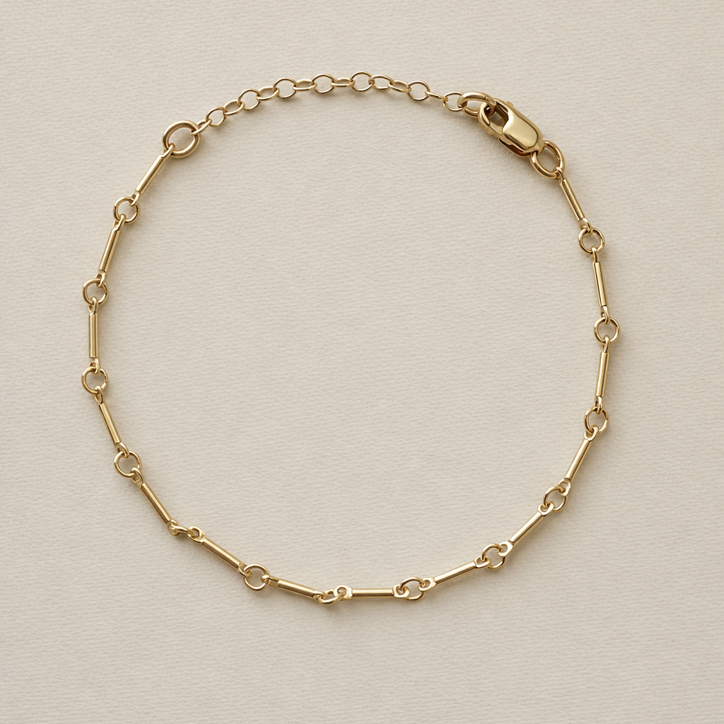 Gold fill bone link bracelet on a beige background with 1 inch extender