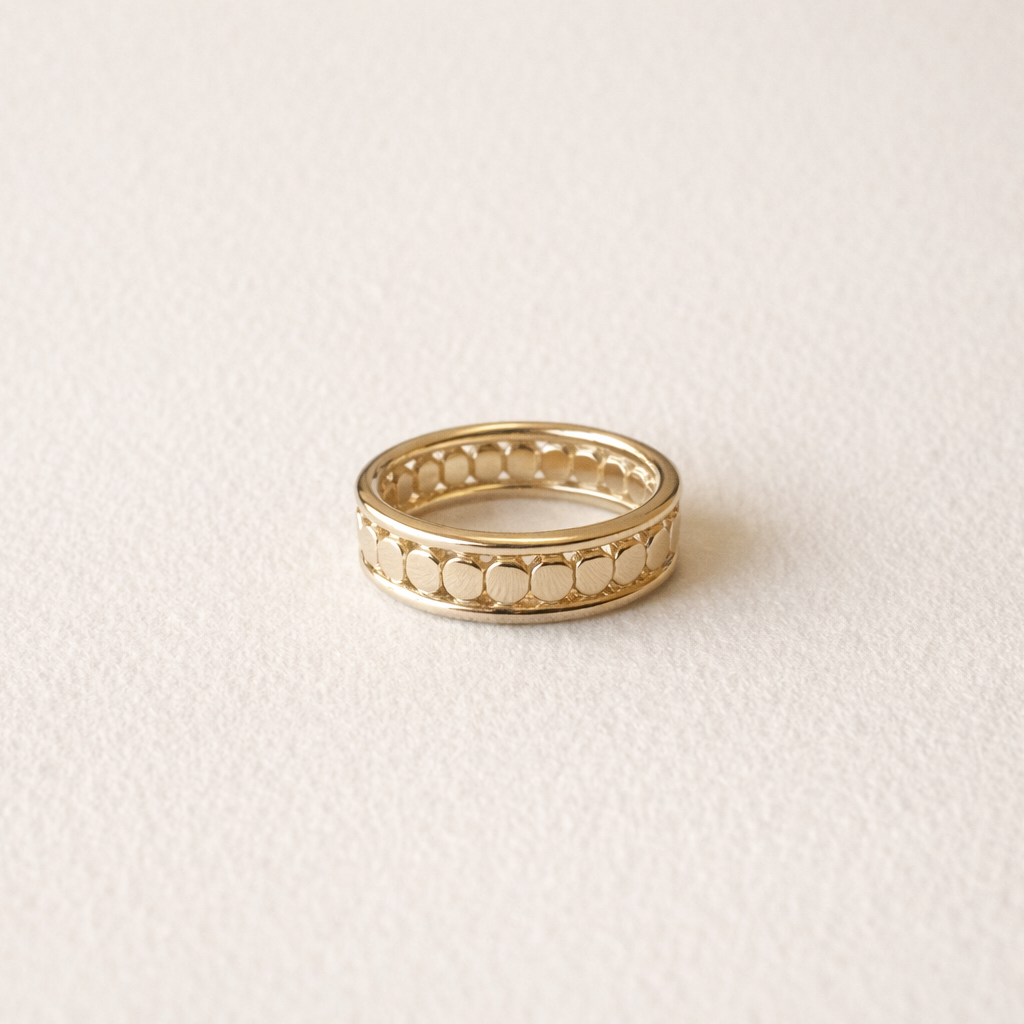 Gold ring on a light beige background