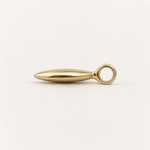 A polished gold metal pendant necklace with a teardrop-shaped key blade, shown on a clean, light off-white background.