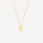 circle 14k solid gold pendant on white background with unique bail handmade