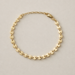 Confettie Disc Gold chain bracelet on a beige background with one inch extender
