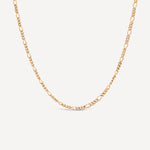 Gold chain necklace on a light beige background