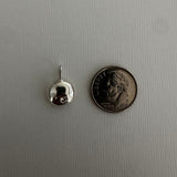 A small silver earring with a butterfly back is shown next to a US dime for scale, on a light gray textured background.