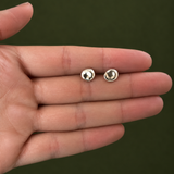 Molten Pebble Studs No. 1, Sterling Silver shown on a hand