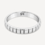 Sterling silver Notch Band flat lay showcasing its sleek profile and elegant design.