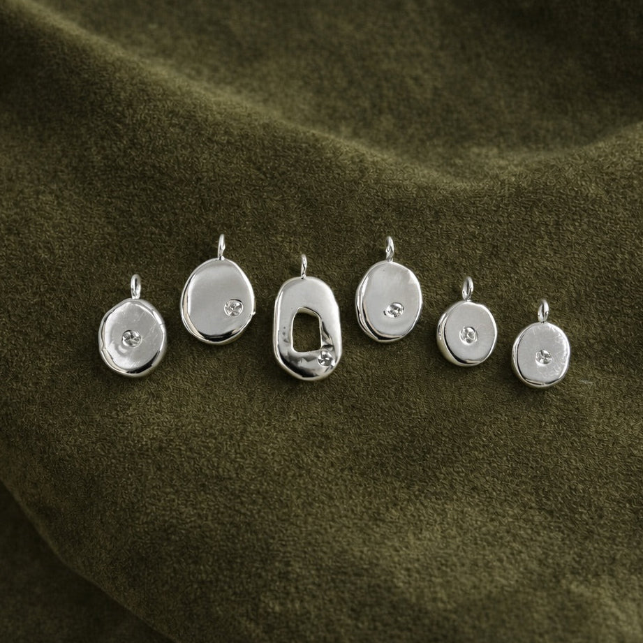 Organic Molten Pendants on olive suede cloth