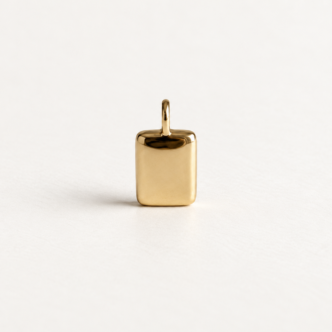 A small polished gold square pendant with a top loop, centered on a clean white background.