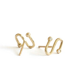 Gold hoop earrings with small diamonds on a white background