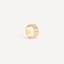 A triple-band brass ring with a polished finish, displayed against a white background.