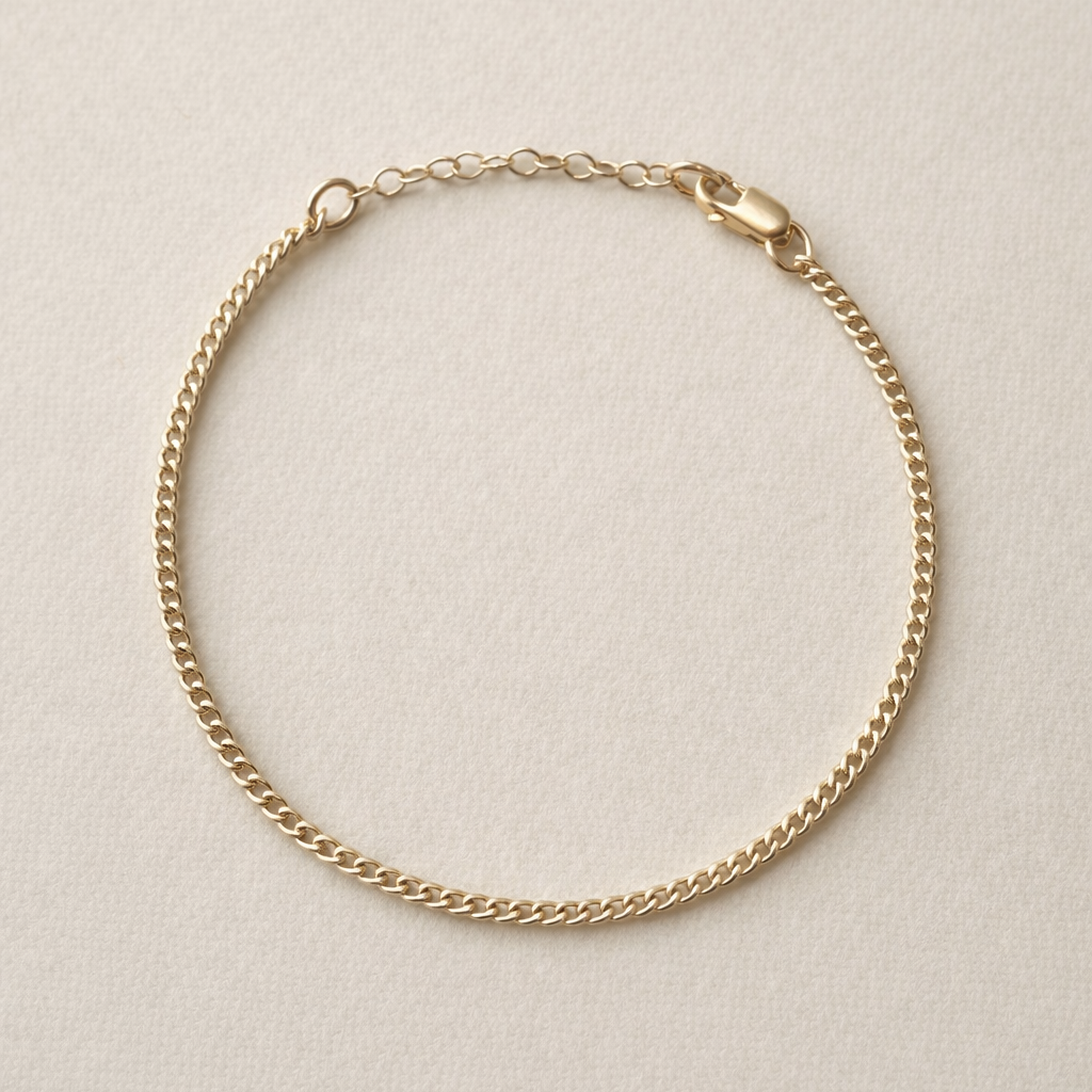 Gold chain bracelet on a beige background
