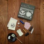 Crafting supplies including a book titled 'Block Parties' on a wooden surface.