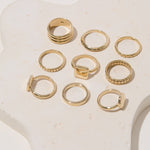 Group of brass rectangle rings arranged on a display, highlighting the minimalist design in various angles.