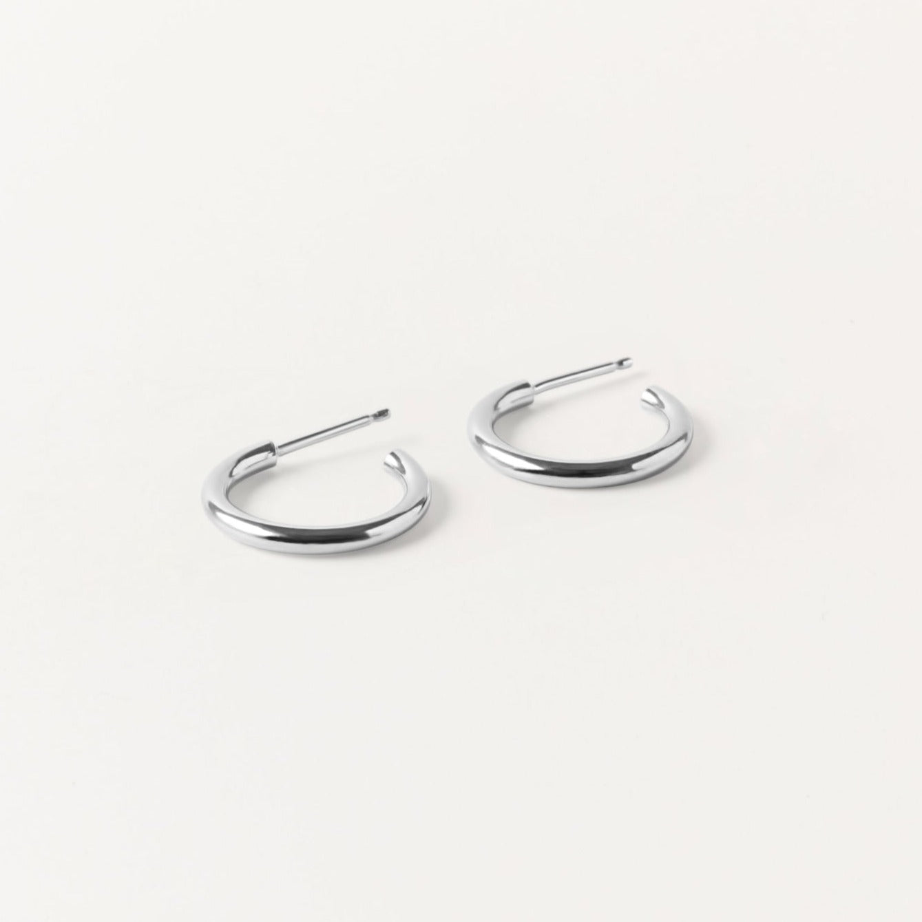 Handcrafted Clea Hoops in sterling silver by Sheena Marshall Jewelry, featuring a polished, solid design with 18mm diameter for timeless style.