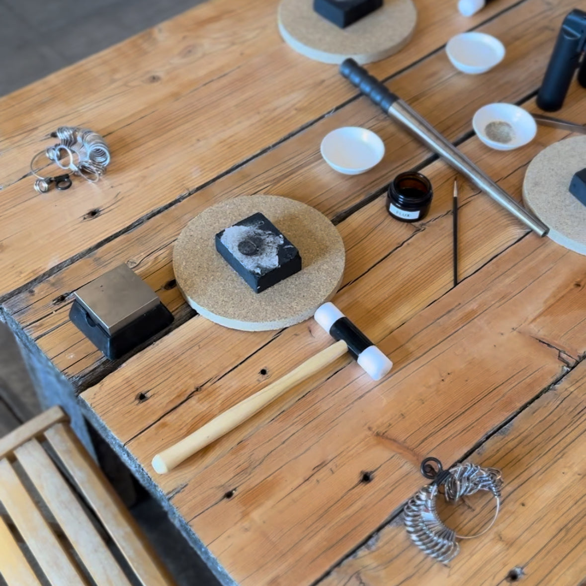 Close-up of hands shaping a silver ring during a jewelry-making class.