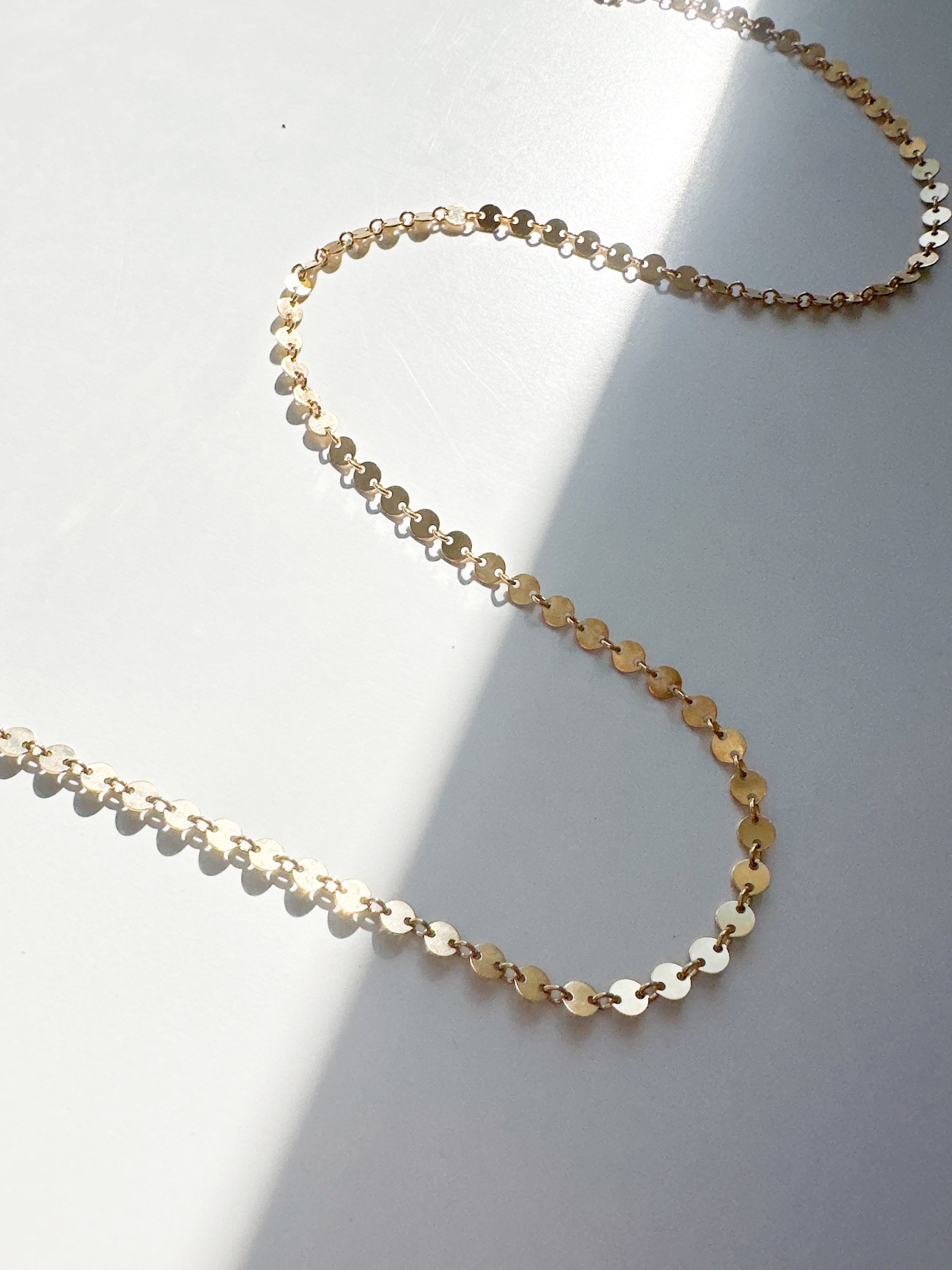 Handcrafted Confetti Necklace in gold fill by Sheena Marshall Jewelry, featuring delicate, light-catching discs for a refined and versatile style.