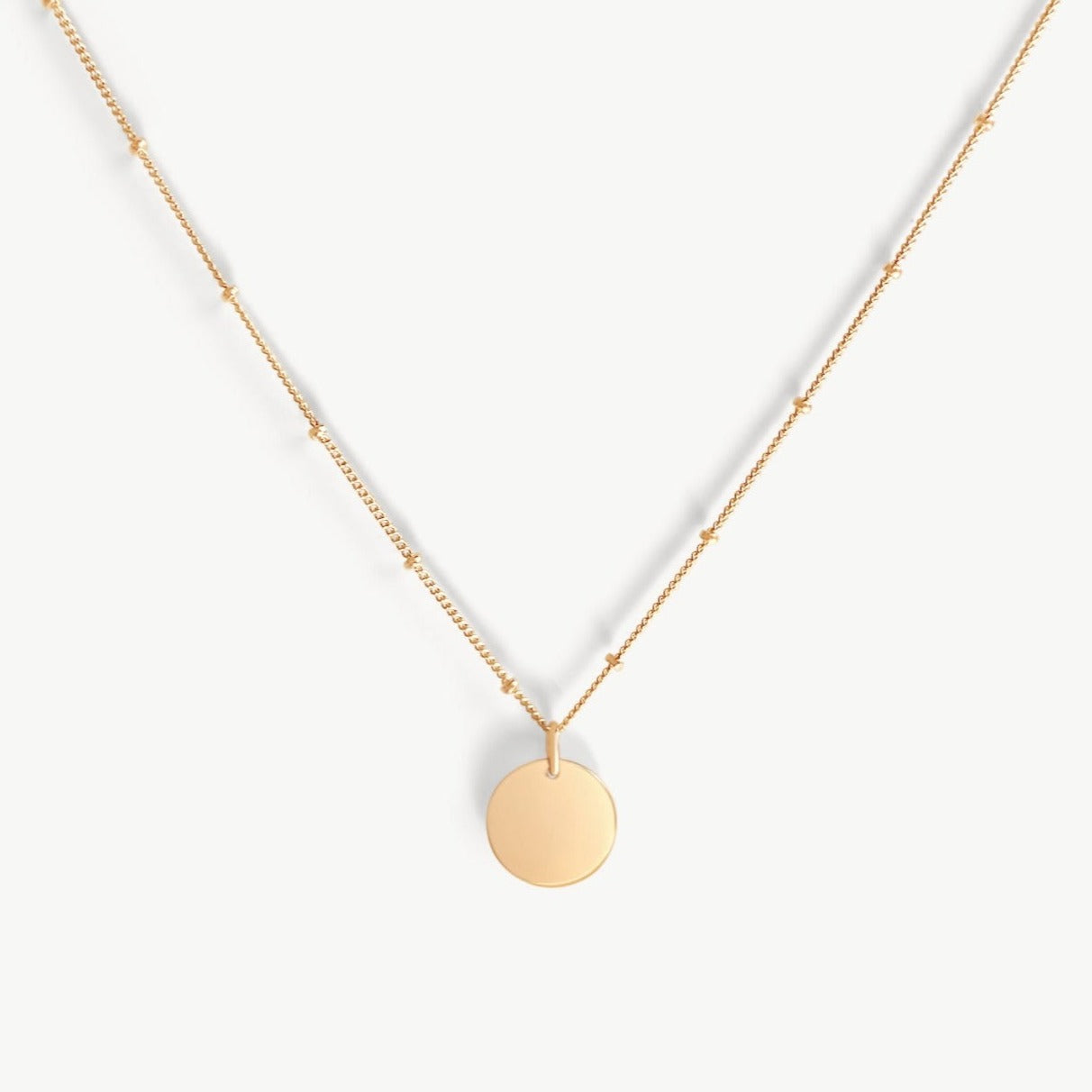 Close-up of the Dylan Link Pendant Necklace in gold fill by Sheena Marshall, featuring a sleek 1/2-inch pendant and textured chain.