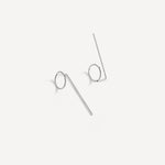 Sterling silver Eloise Threader Earrings laid flat, showing their minimalist hand-formed design.