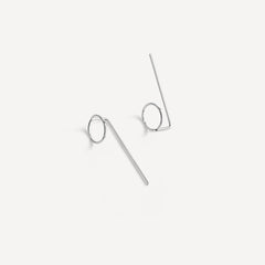 Sterling silver Eloise Threader Earrings laid flat, showing their minimalist hand-formed design.