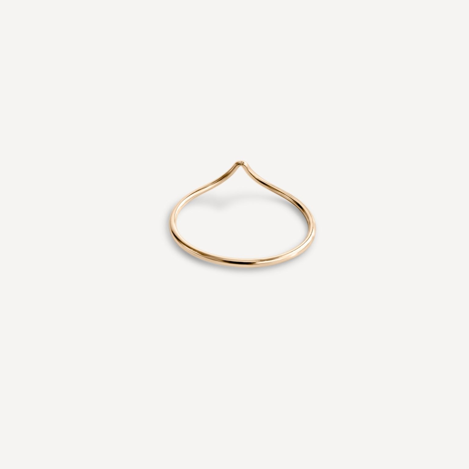 Emilie Arch Ring stacked with other delicate gold rings.