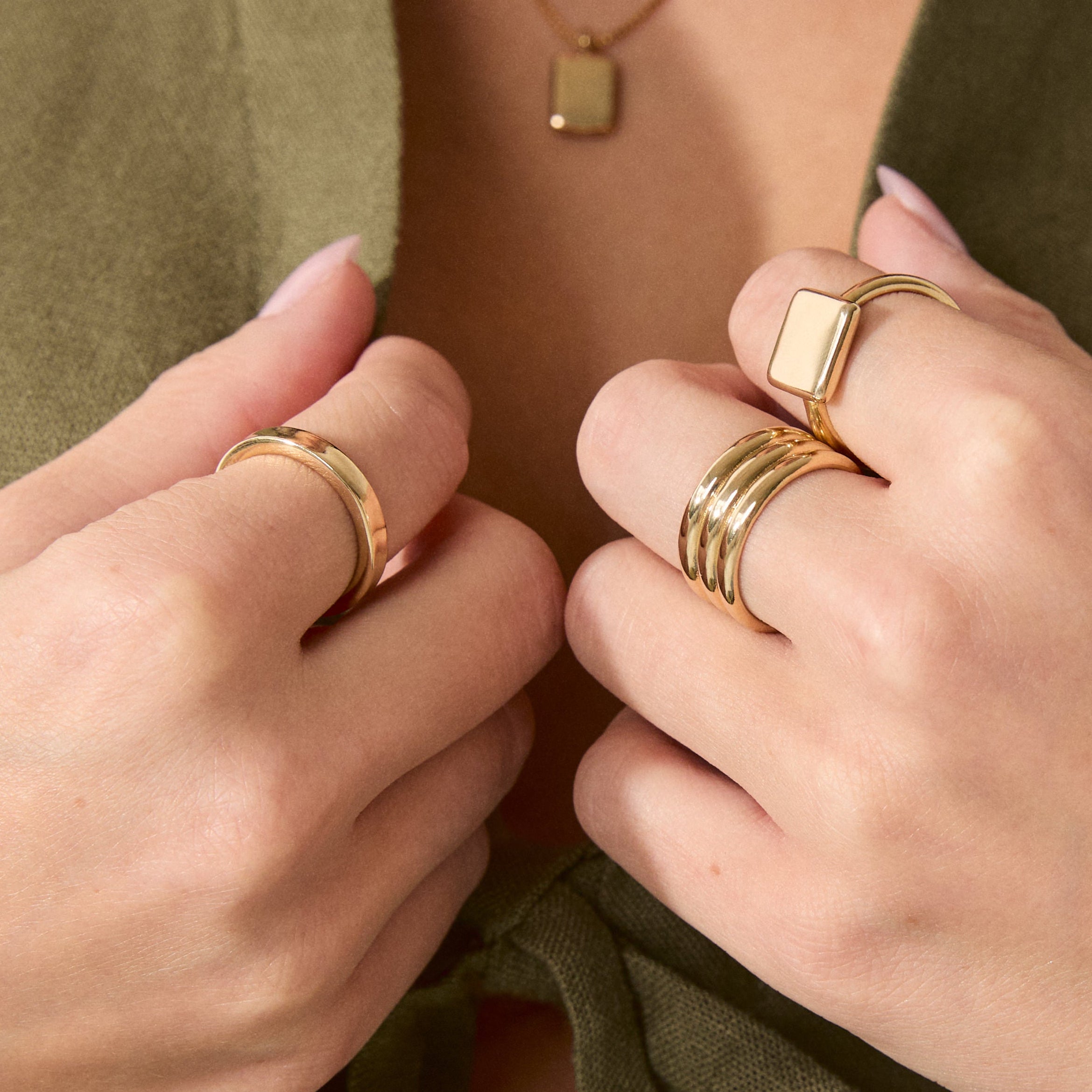 Everyday Band, 14k Solid Gold stacked with other rings on a model's hand