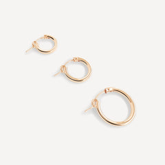 Three sizes of gold-filled everyday hoop earrings displayed on a neutral background.