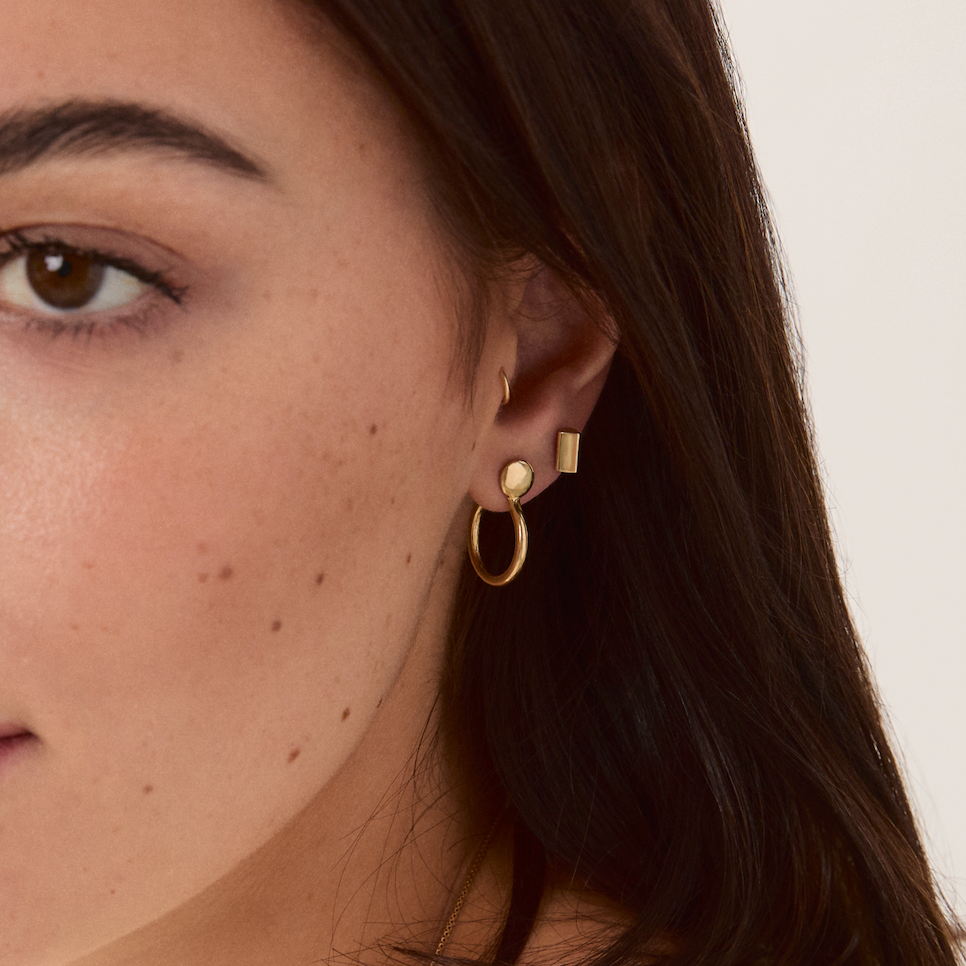 Model wearing the Forma Circle Hoops showcasing their polished finish and minimalist design.