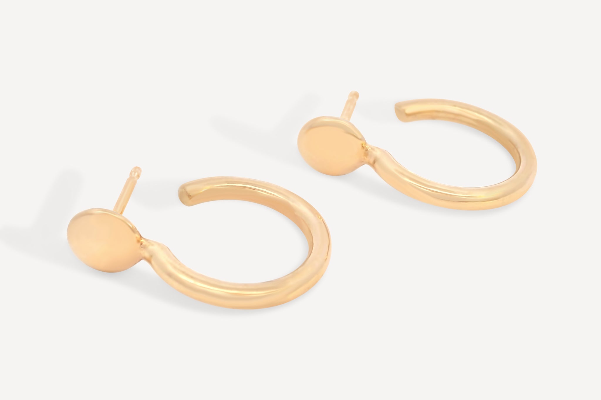 Pair of Forma Circle Hoops made from recycled 14k solid gold, displayed on a neutral background.