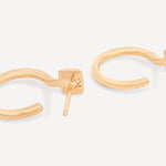 Side view of Forma Rectangle Hoops in 14k solid gold, highlighting their minimalist profile and polished finish.