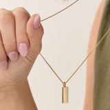 forma_triangle_knife_edge_gold_pendant on model rounded box chain 14k gold