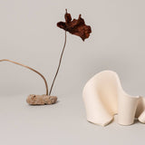 Furl Art Object, Bone displayed with a flower vase