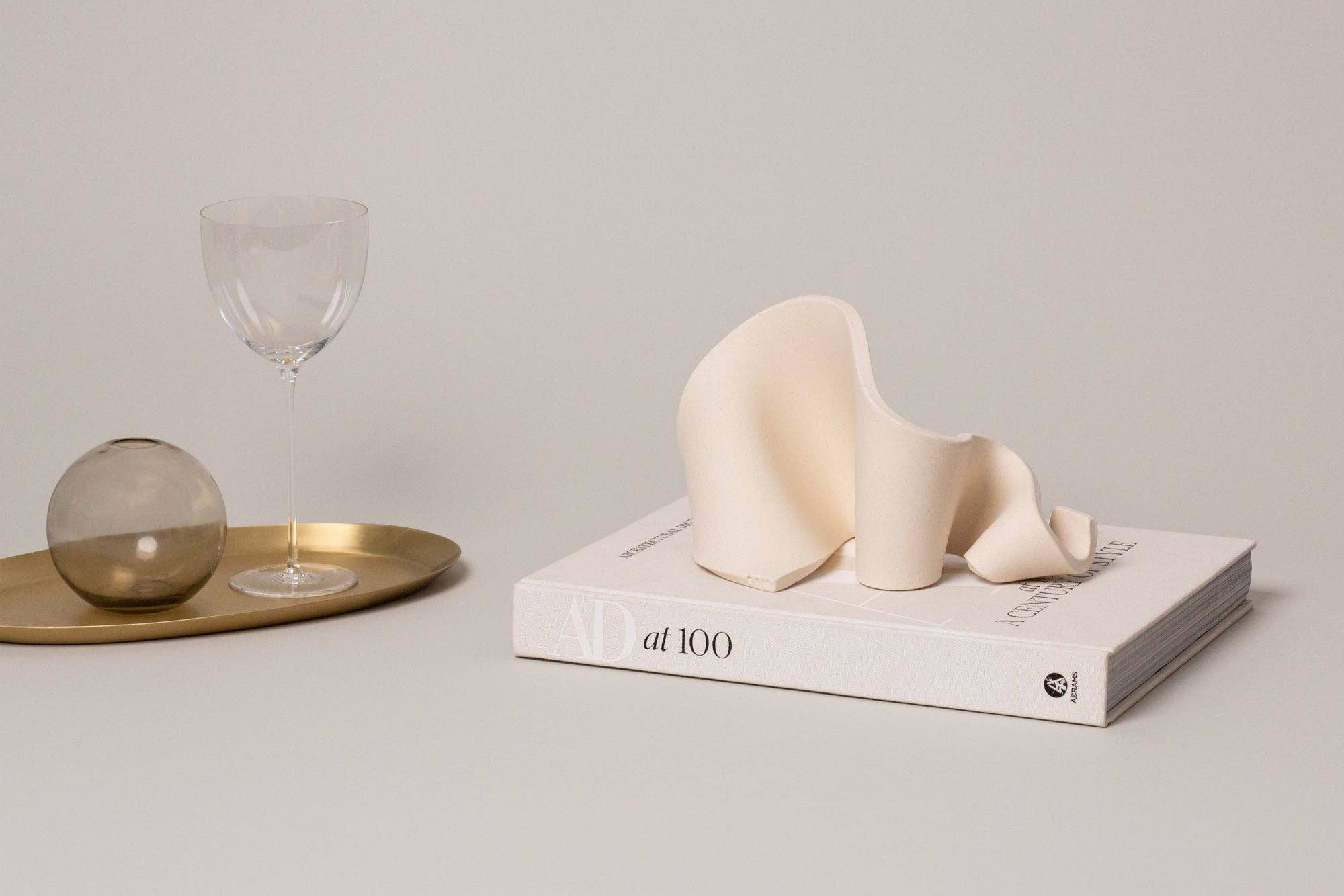 Furl Art Object, Bone styled with a book and tray