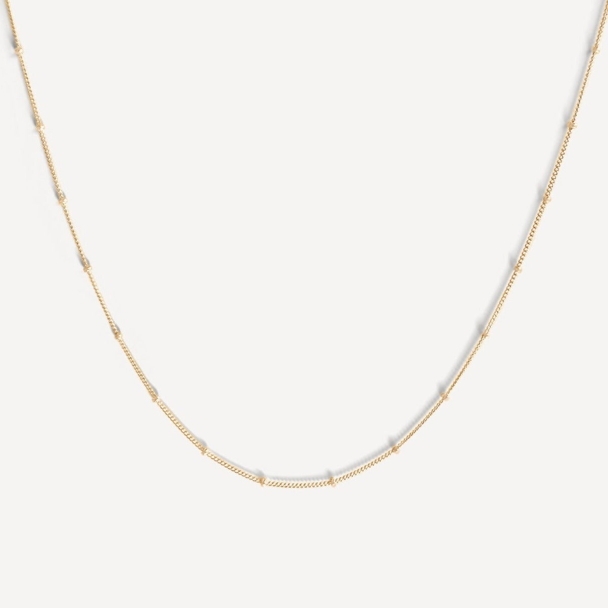 Close-up of the Essential Capsule Satellite Chain Necklace in gold fill.