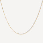 Close-up of the Essential Capsule Satellite Chain Necklace in gold fill.