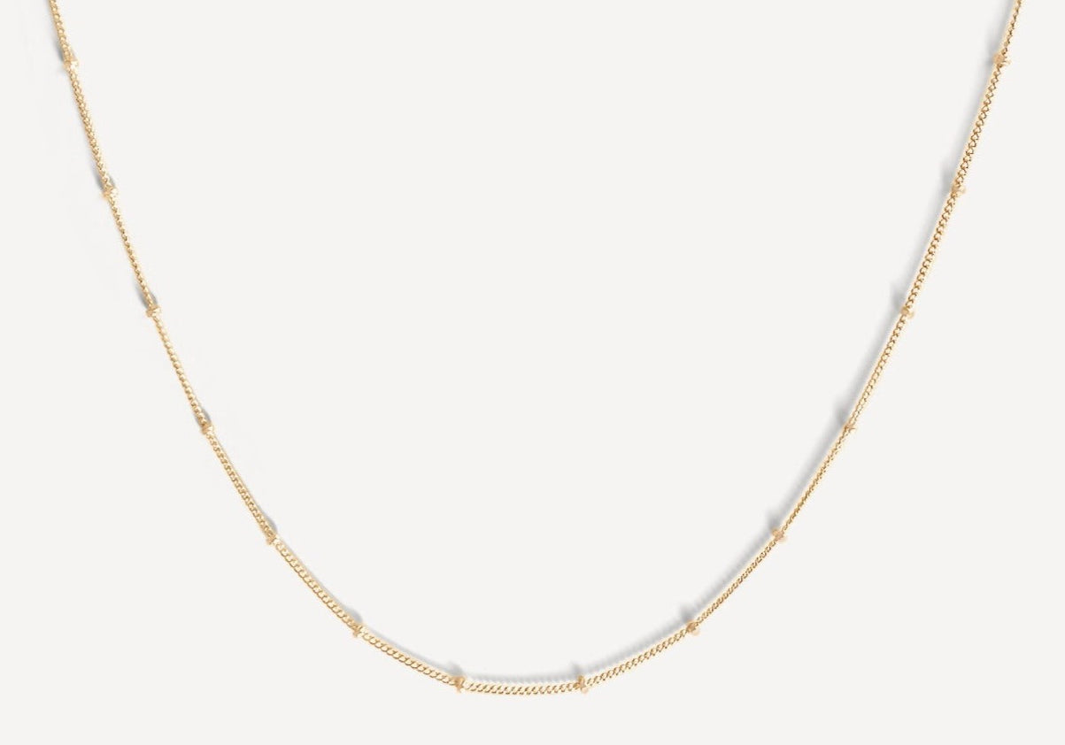 Close-up of the Essential Capsule Satellite Chain Necklace in gold fill.