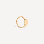 Side view of the solid gold signet ring, highlighting its smooth band and polished round face.